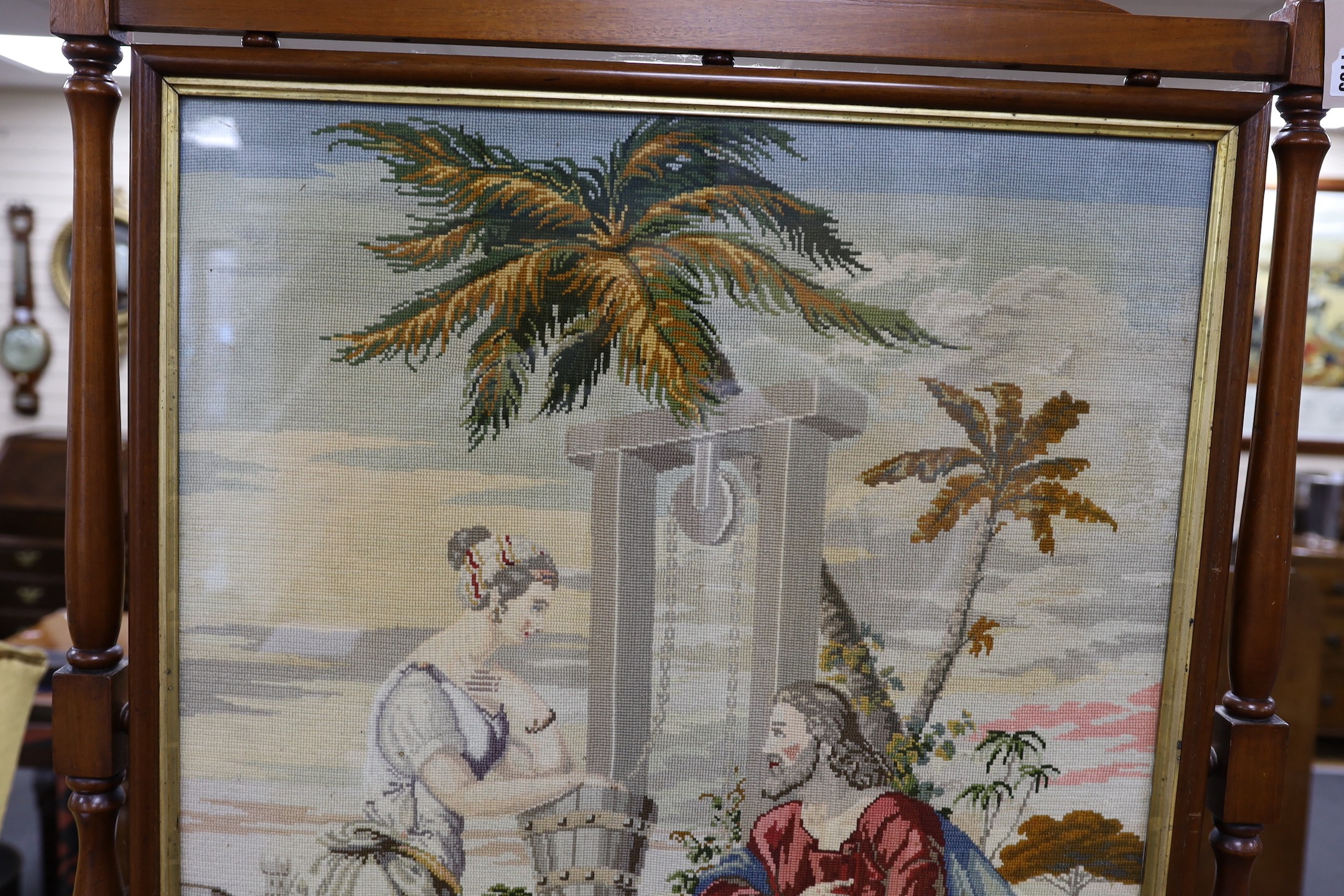 A large Victorian mahogany framed needlepoint firescreen, height 132.5cm high, width 86cm